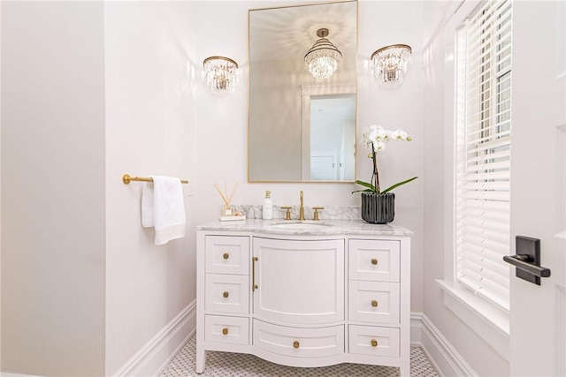 bathroom with vanity, baseboards, and tile patterned flooring