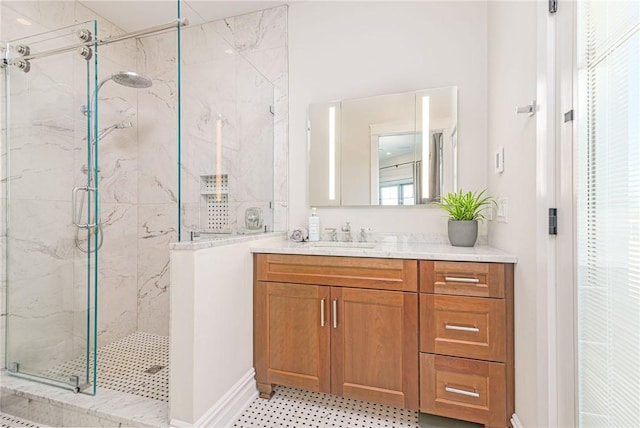 bathroom with a marble finish shower and vanity