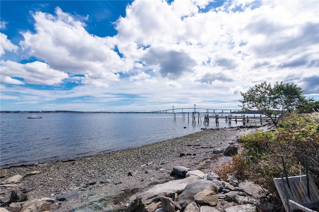 view of dock featuring a view of the beach and a water view