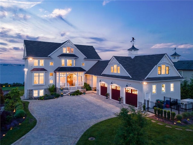 10 Coulter St, Jamestown, RI 02835 - shingle-style home with decorative driveway, an attached garage, stone siding, and a shingled roof