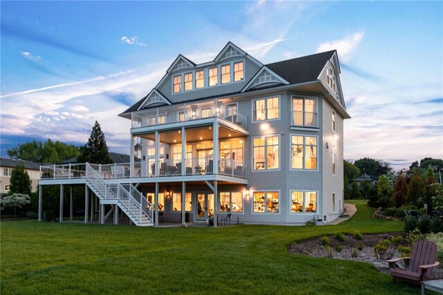 10 Coulter St, Jamestown, RI 02835 - rear view of house featuring stairs, a lawn, a wooden deck, and a sunroom
