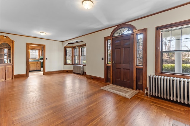 200 Pond St, South Kingstown, RI 02879 - foyer entrance featuring radiator heating unit, wood-type flooring, ornamental molding, and baseboards
