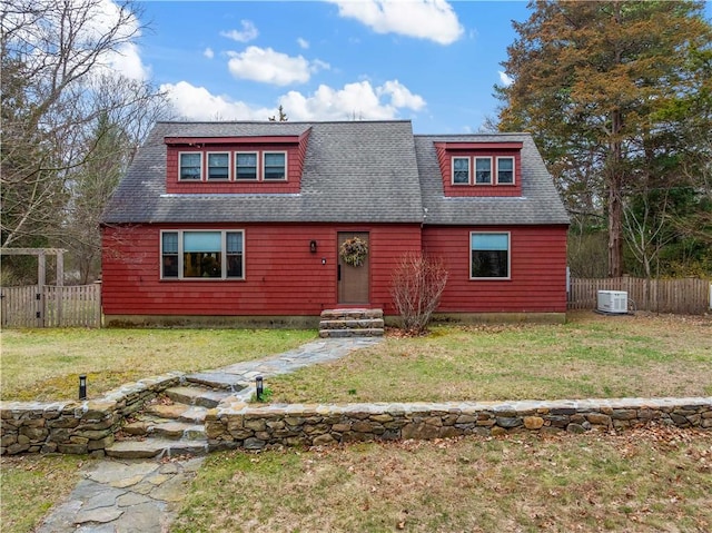 view of front of home featuring central AC, a front lawn, fence, and roof with shingles