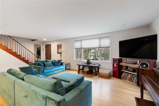 living room with wood finished floors, recessed lighting, and stairway
