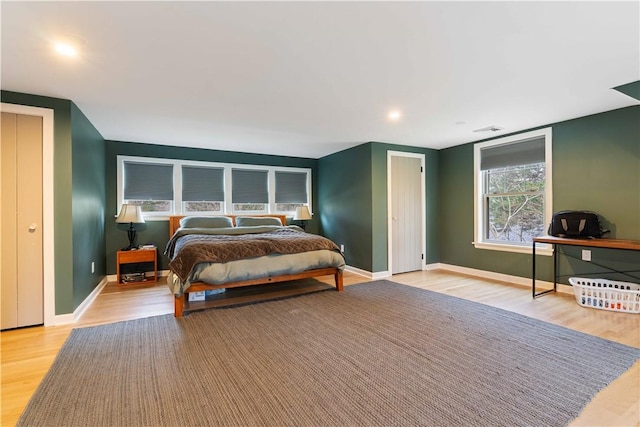 bedroom with wood finished floors, baseboards, and recessed lighting