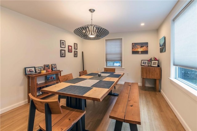 dining area with baseboards, light wood-type flooring, and recessed lighting