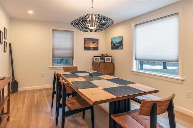 dining space with light wood-style flooring, baseboards, and recessed lighting