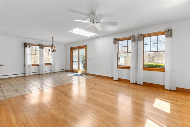 200 Pond St, South Kingstown, RI 02879 - interior space with baseboards, ceiling fan with notable chandelier, wood finished floors, and a skylight