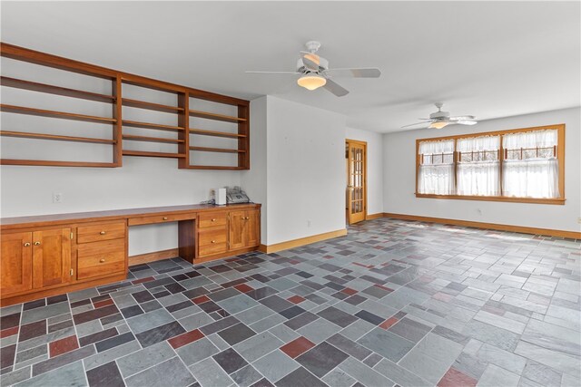 200 Pond St, South Kingstown, RI 02879 - interior space with baseboards, built in study area, open shelves, brown cabinetry, and ceiling fan