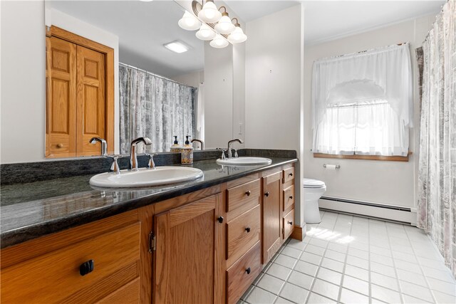 200 Pond St, South Kingstown, RI 02879 - bathroom featuring toilet, a baseboard radiator, double vanity, and a sink