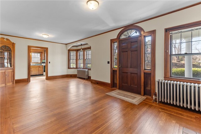 200 Pond St, South Kingstown, RI 02879 - entrance foyer featuring hardwood / wood-style floors, ornamental molding, and radiator