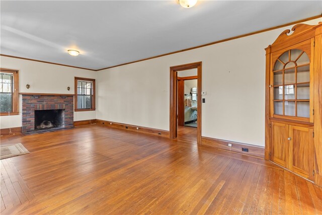 200 Pond St, South Kingstown, RI 02879 - unfurnished living room featuring crown molding, a fireplace, baseboards, and hardwood / wood-style flooring