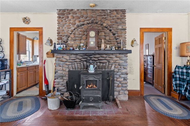 200 Pond St, South Kingstown, RI 02879 - living room featuring baseboards, a fireplace, crown molding, a textured ceiling, and wood finished floors