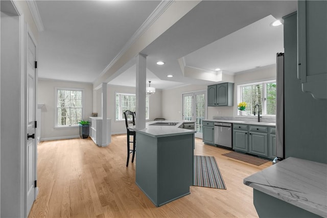 kitchen featuring a sink, dishwasher, and crown molding