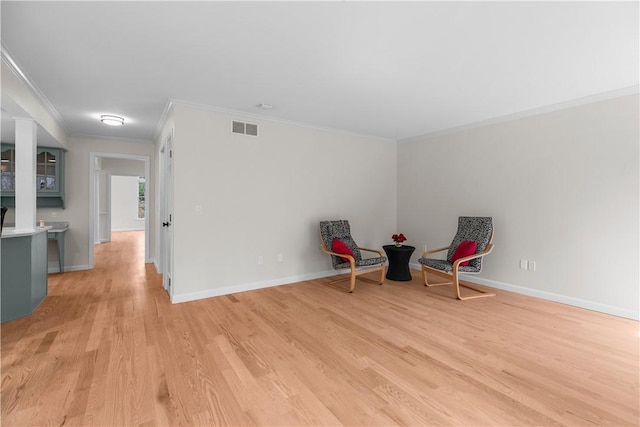 unfurnished room featuring light wood-type flooring, baseboards, and visible vents