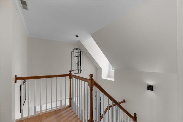 staircase featuring visible vents and lofted ceiling