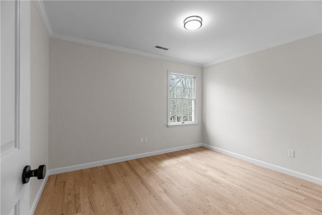 unfurnished room featuring crown molding, light wood finished floors, baseboards, and visible vents