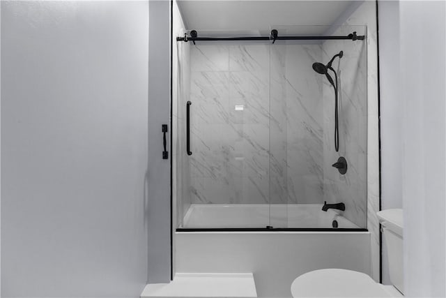 full bathroom with bath / shower combo with glass door and toilet