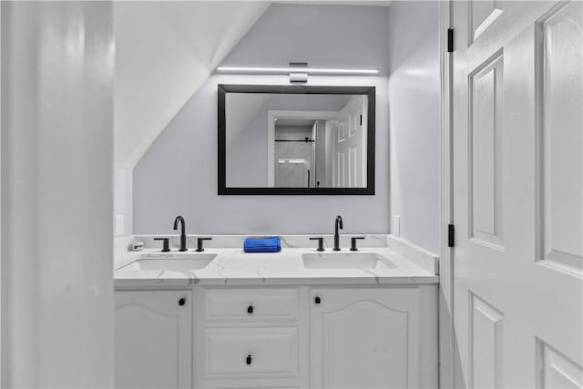 bathroom featuring double vanity and a sink