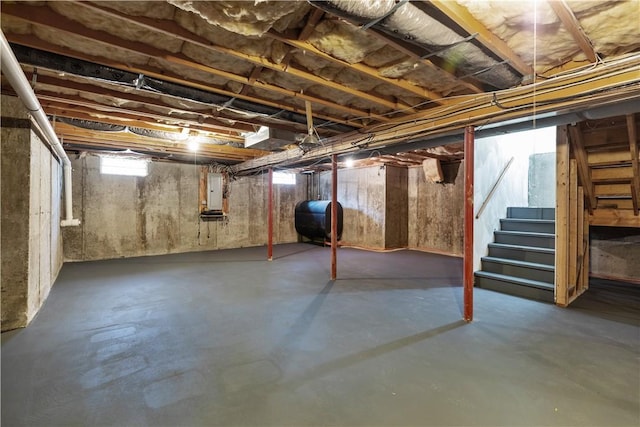 basement featuring stairway and heating fuel