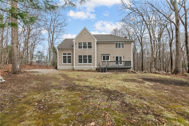 rear view of property with a chimney and a wooden deck