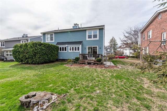 83 Wyndham Ave, Providence, RI 02908 - back of house featuring a deck, a lawn, and a chimney