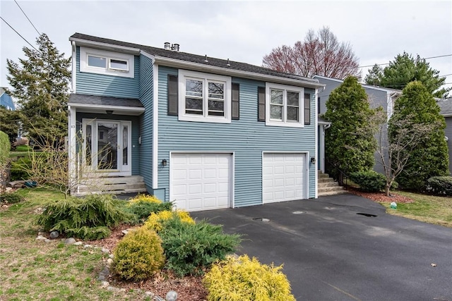 83 Wyndham Ave, Providence, RI 02908 - view of front facade with driveway and a garage