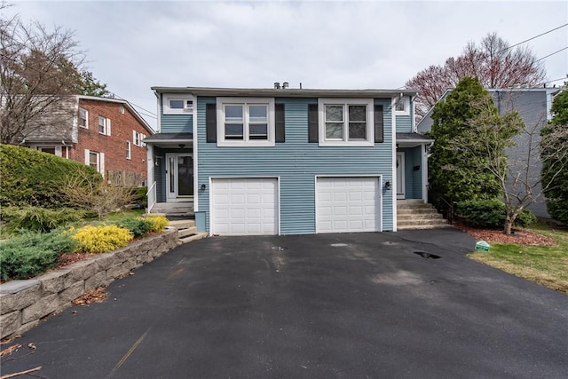 83 Wyndham Ave, Providence, RI 02908 - tri-level home with an attached garage and driveway