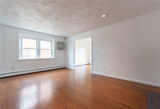 83 Wyndham Ave, Providence, RI 02908 - unfurnished room featuring a textured ceiling, baseboard heating, wood finished floors, a baseboard radiator, and baseboards