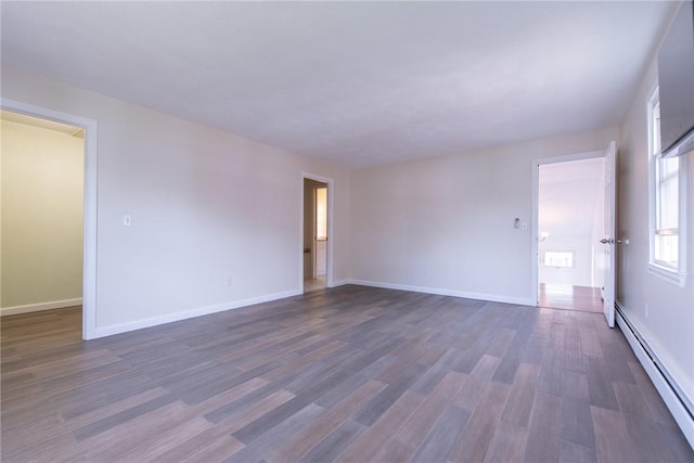 83 Wyndham Ave, Providence, RI 02908 - empty room featuring a baseboard heating unit, baseboards, and dark wood-style flooring