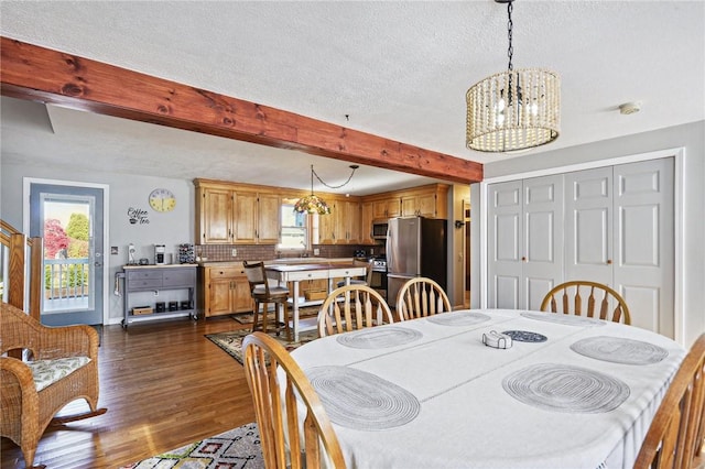 dining room featuring beamed ceiling, a notable chandelier, dark wood-style floors, and plenty of natural light