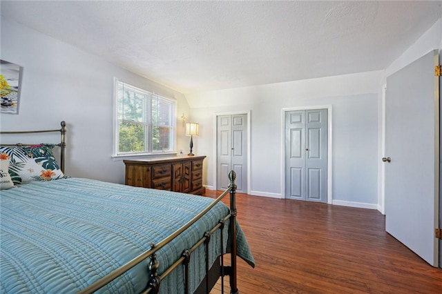 bedroom with baseboards and wood finished floors