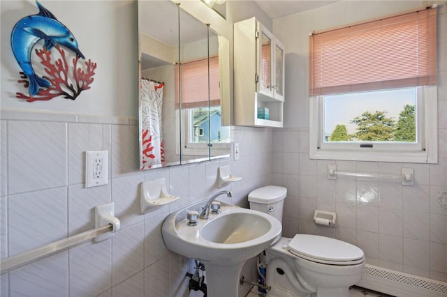 full bathroom featuring a sink, toilet, a baseboard heating unit, and a shower with curtain