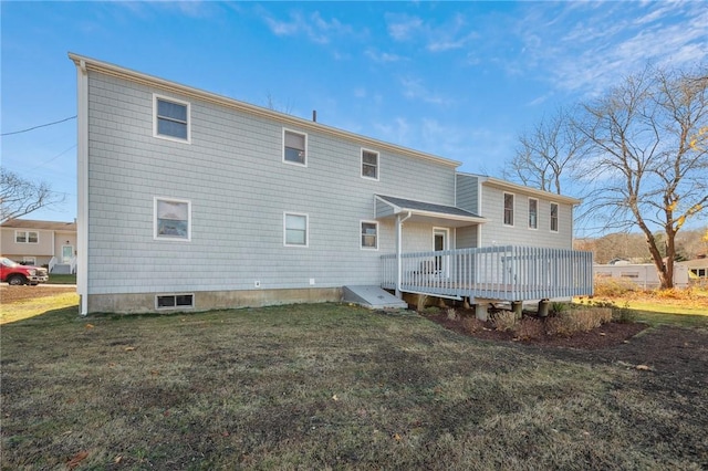rear view of property with a yard and a deck