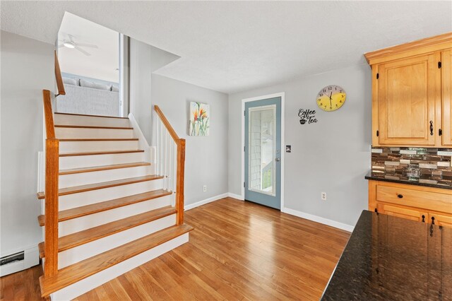 133 Old Pine Rd, Narragansett, RI 02882 - foyer entrance featuring light wood finished floors, baseboards, stairs, ceiling fan, and baseboard heating