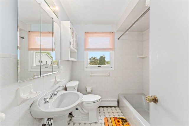 133 Old Pine Rd, Narragansett, RI 02882 - bathroom featuring toilet, baseboard heating, tile walls, shower / bath combination, and plenty of natural light