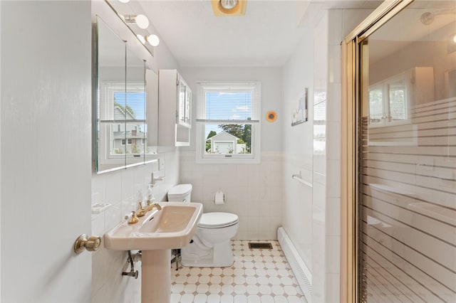 133 Old Pine Rd, Narragansett, RI 02882 - full bathroom featuring toilet, a shower stall, tile walls, wainscoting, and tile patterned floors