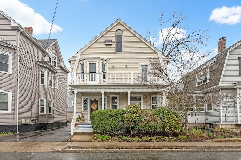 view of front of property with a porch and a balcony