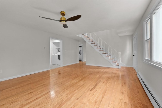 unfurnished living room with ceiling fan, light wood-type flooring, a baseboard heating unit, stairs, and baseboards