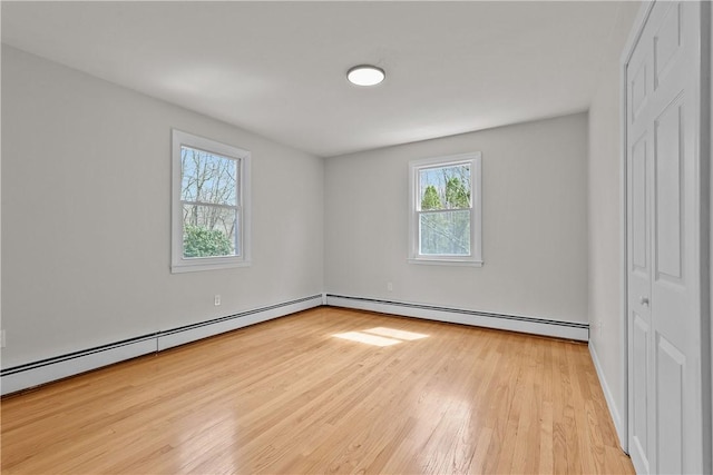 interior space featuring wood finished floors and baseboard heating