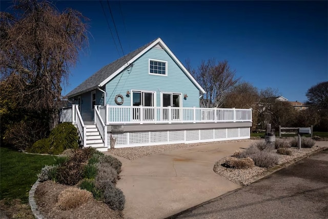 rear view of house featuring a deck