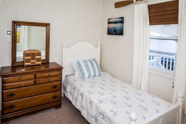 bedroom with dark carpet and a ceiling fan