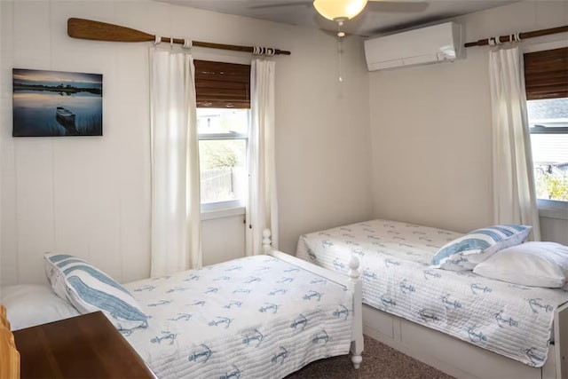 carpeted bedroom with ceiling fan and a wall mounted AC
