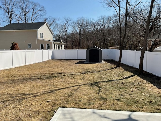 view of yard with a fenced backyard, an outdoor structure, and a shed