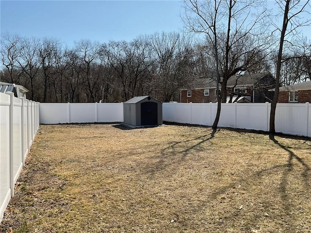 view of yard featuring a fenced backyard, an outbuilding, and a storage unit