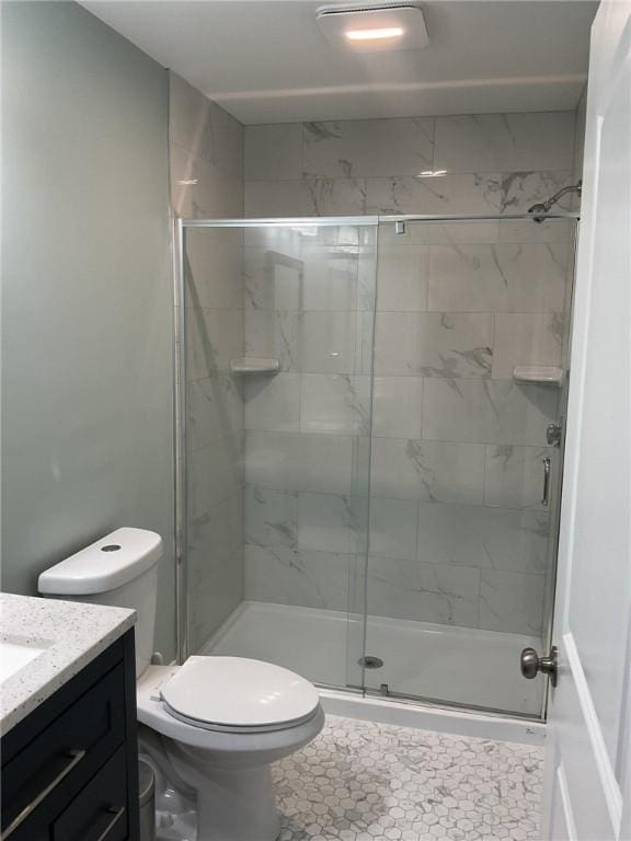 full bath with a shower stall, toilet, and vanity