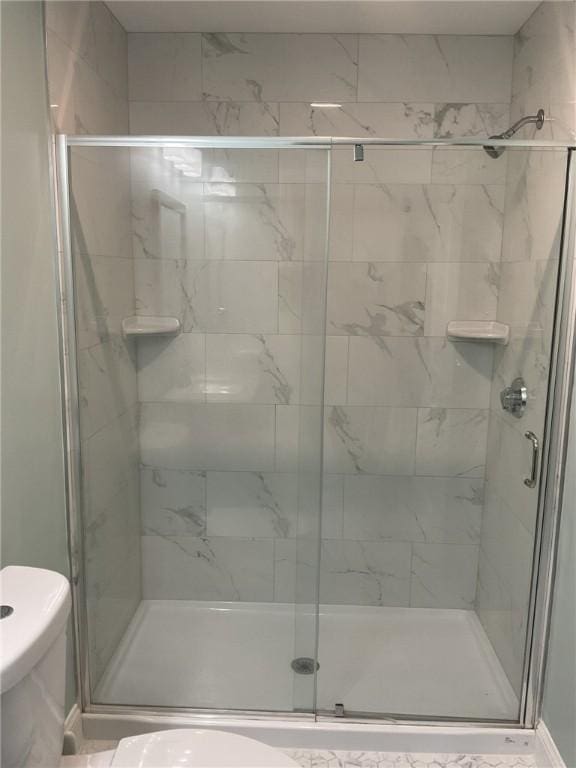 full bath with a shower stall and toilet