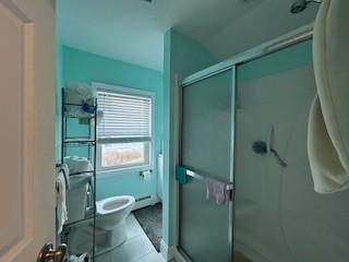 full bath featuring toilet and a stall shower