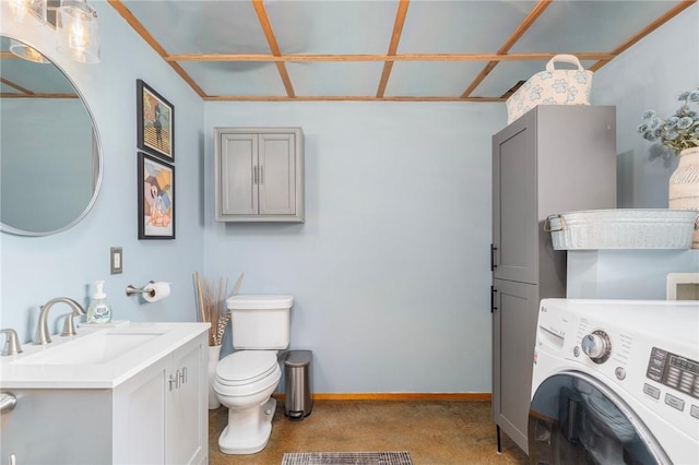 bathroom featuring baseboards, washer / clothes dryer, toilet, and vanity