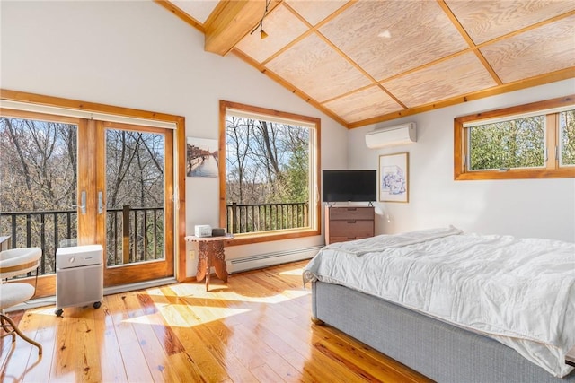 bedroom with hardwood / wood-style flooring, a wall mounted AC, a baseboard heating unit, and multiple windows